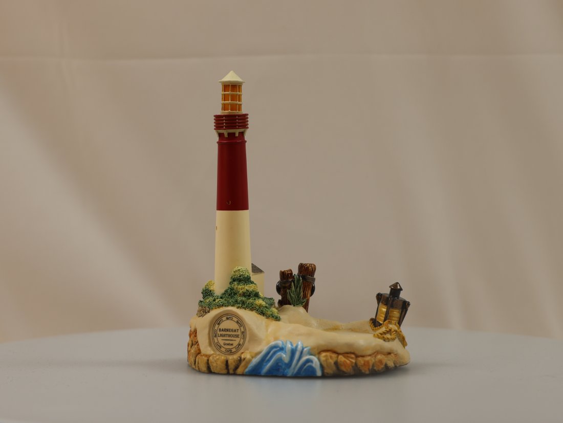 GOEBEL/ HUMMEL "BY THE SEA" ASSATEAGUE LIGHTHOUSE: The Goebel/Hummel "By the Sea" Assateague Lighthouse is a delightful and collectible figurine that showcases the charm and craftsmanship associated with Hummel figurines. This particular figurine depi