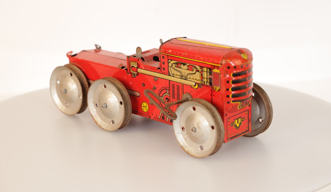Louis Marx & Company Vintage Tin Litho Wind-Up Toy Tractors: Step back in time with this charming pair of vintage tin litho wind-up toy tractors, a delightful addition to any antique toy collection. Each tractor, adorned with vivid graphics and intricate detail