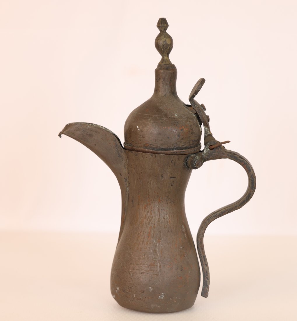 Antique Middle Eastern Dallah Coffee Pot with Finial Lid: Vintage Chinese brass vases come in a variety of styles, shapes, and sizes. They are often adorned with traditional Chinese motifs, such as dragons, phoenixes, floral patterns, or intricate geometric