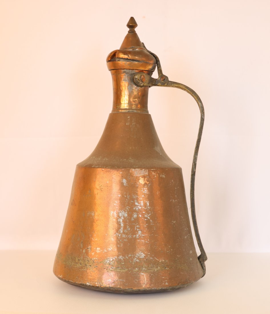 Large Antique Middle Eastern Copper Ewer with Finial Lid: Presenting a remarkable antique Middle Eastern copper ewer, characterized by its grand size, gracefully curved spout, and ornate finial lid. This beautifully aged piece showcases the craftsmanship and