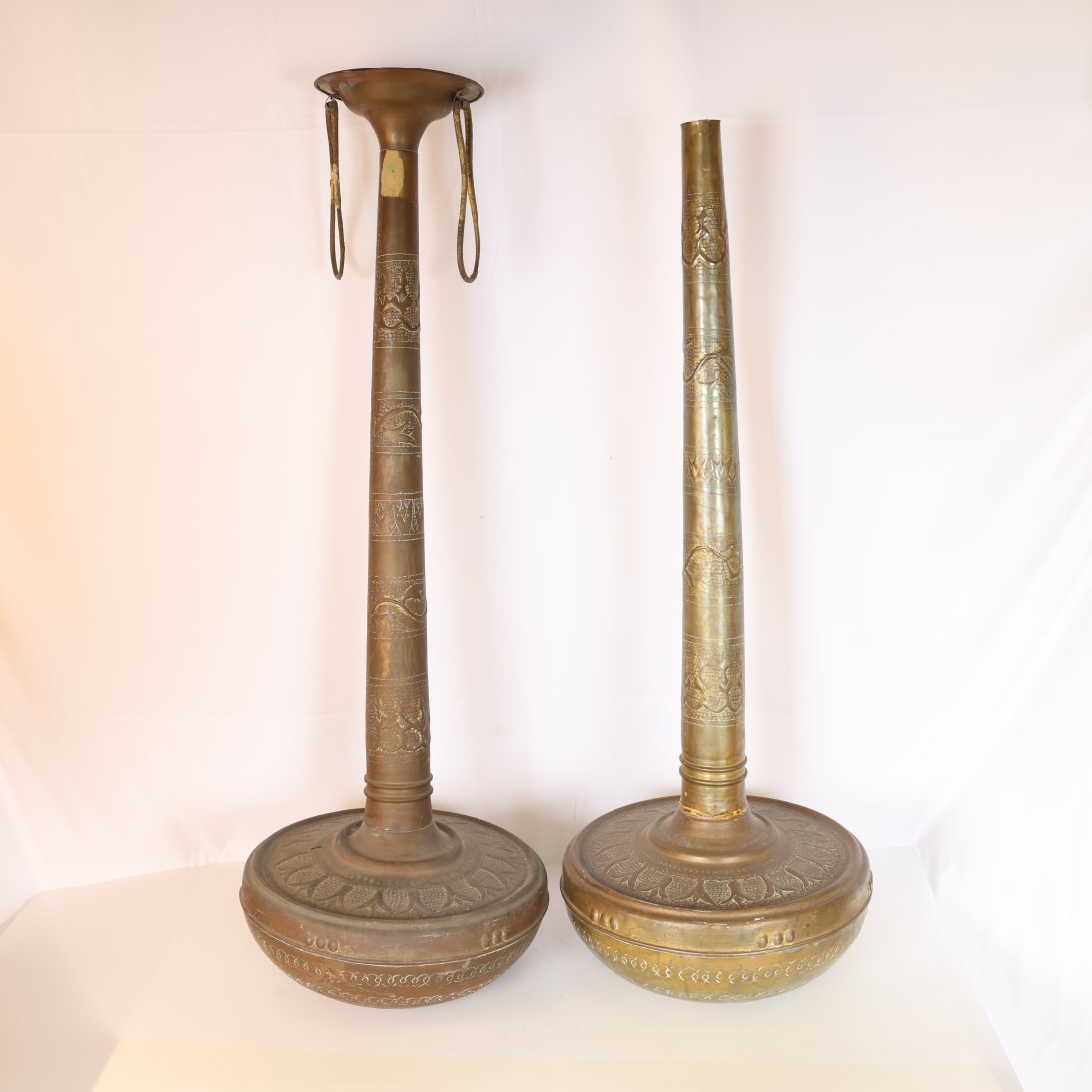 Pair of Antique Brass Antique Middle Eastern Islamic Persian Arabic Chased Brass Long Neck: Presenting a remarkable pair of antique brass Antique Middle Eastern Islamic Persian Arabic Chased Brass Long Neck stand vases, intricately handcrafted with exquisite detail. These stand vases, typica
