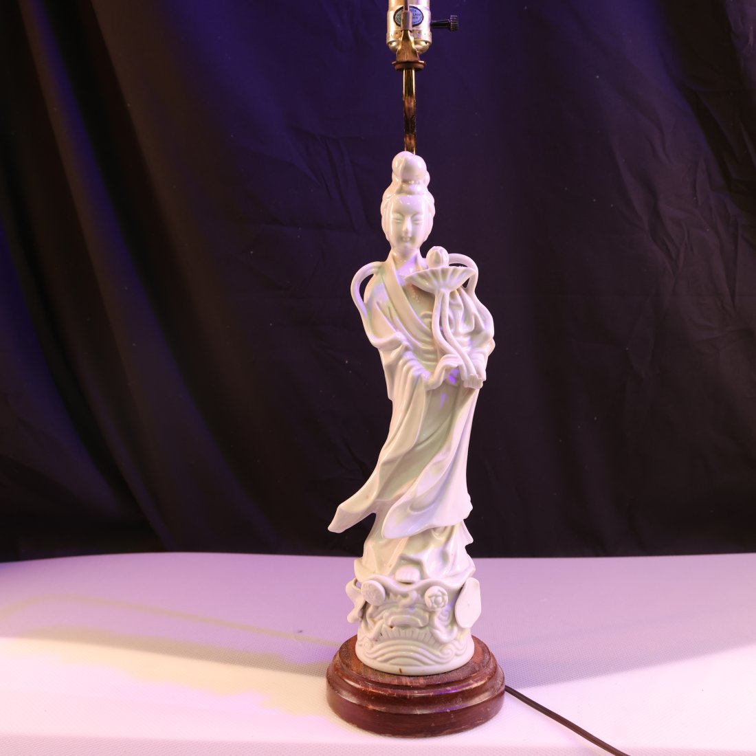 Vintage Blanc de Chine Figurine Lamp: Enhance your home decor with this stunning vintage Asian porcelain figurine table lamp. This beautifully crafted piece showcases an elegant figure, standing gracefully with a serene expression. The in