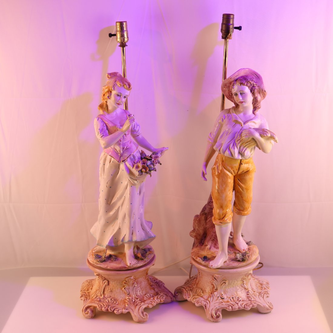 Pair of Vintage Capodimonte Style Figural Lamps: Enhance your home decor with this charming pair of vintage Capodimonte style figural lamps. These exquisite lamps feature beautifully crafted porcelain figures, each depicting a young man and woman in