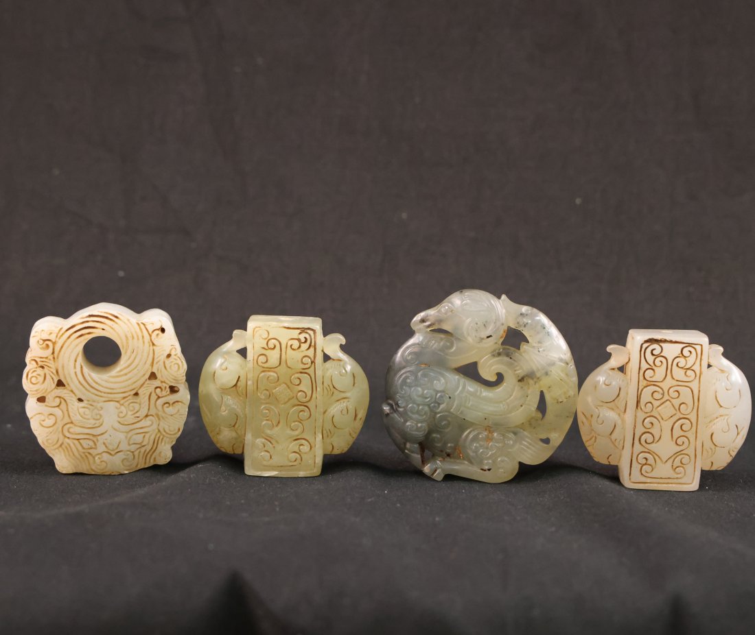 Collection of Four Exquisite Antique Chinese Jade Carvings: Presenting a remarkable collection of four antique Chinese jade carvings, each exquisitely crafted and rich in cultural symbolism. These intricate pieces showcase the exceptional artistry and skilled 