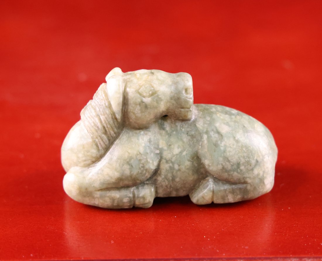 Vintage Chinese Jade Horse Figurine: Description:This remarkable vintage Chinese jade figurine depicts a resting horse, a symbol of endurance and tranquility. The horse is skillfully carved with detailed attention to its relaxed posture,