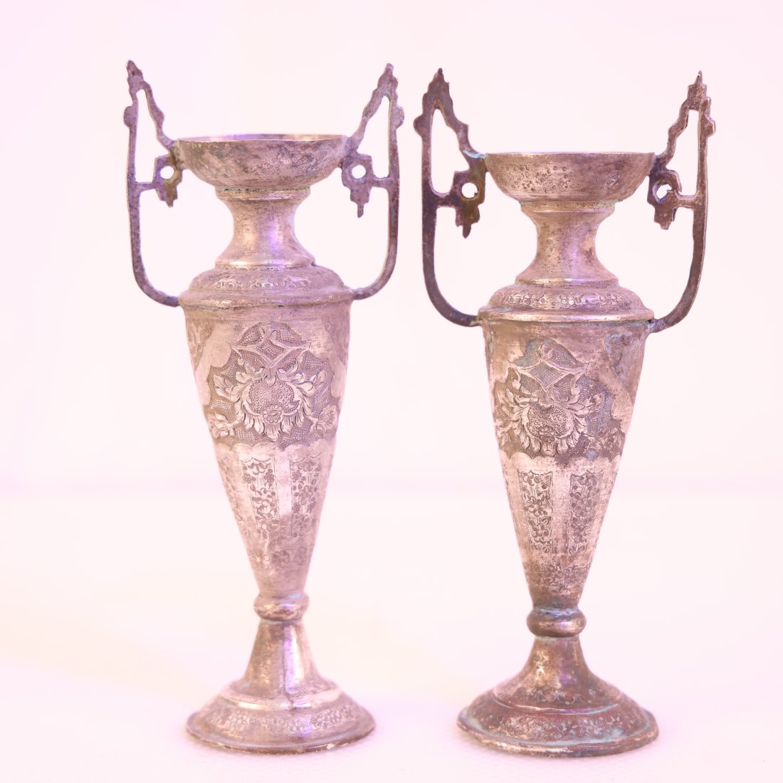 Pair of Persian Sterling Silver Vases 278 grams: This elegant pair of antique Persian sterling silver vases showcases the intricate artistry and refined craftsmanship characteristic of Persian metalwork. Each vase features beautifully detailed engra