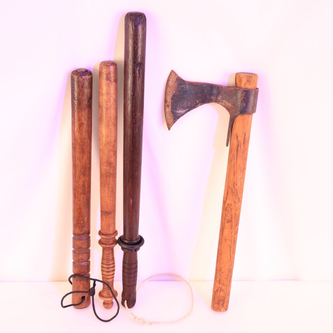 Vintage Collection of Wooden Police Batons and Hatchet: Presenting a unique collection of vintage wooden police batons and a rustic hatchet, perfect for collectors of antique weaponry or historical artifacts. This set includes three distinct wooden batons