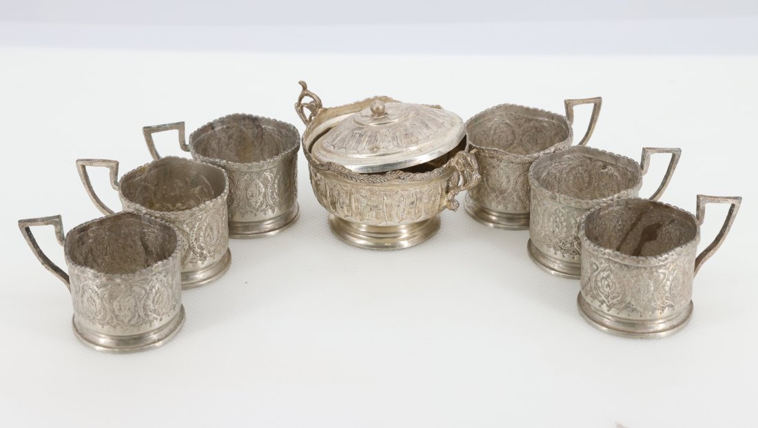 Antique Persian Silver Tea Glass Holders with Sugar Bowl - Set of 7: Presenting a beautiful set of antique Persian silver tea glass holders accompanied by a matching sugar bowl with a lid. This elegant set includes six intricately designed tea glass holders and a sugar