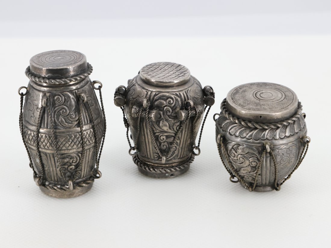 Set of Three Antique Persian Silver Spice Jars: Each jar is uniquely designed, with delicate chains and detailed lids, adding to their charm and functionality. These jars are perfect for storing spices or small treasures, and they serve as stunning