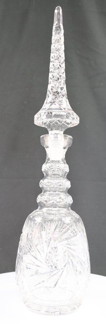 Hand-Cut Crystal Decanter with Tall Stopper from the Czech Republic: Introducing an exquisite hand-cut crystal decanter, complete with an impressive tall stopper, crafted in the Czech Republic. This stunning piece is made from 24% lead crystal, renowned for its clarity