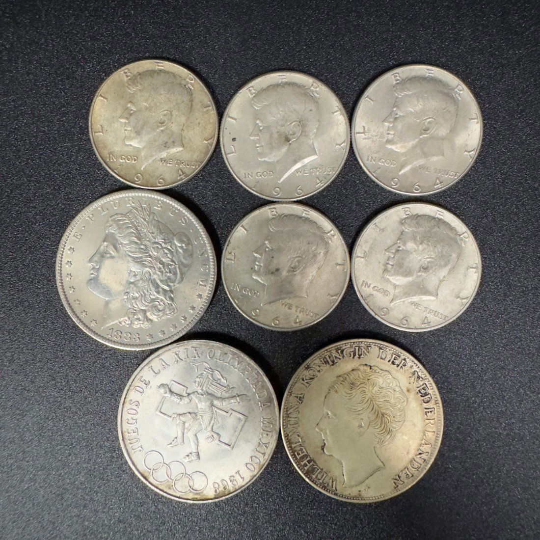Exceptional Collection of Vintage U.S. Silver Coins and Rare Olympic Dollar: Discover the allure of history and the thrill of collecting with this exceptional set of vintage U.S. silver coins, featuring a standout 1987 Olympic silver dollar. This lot includes:1987 Olympic Silv