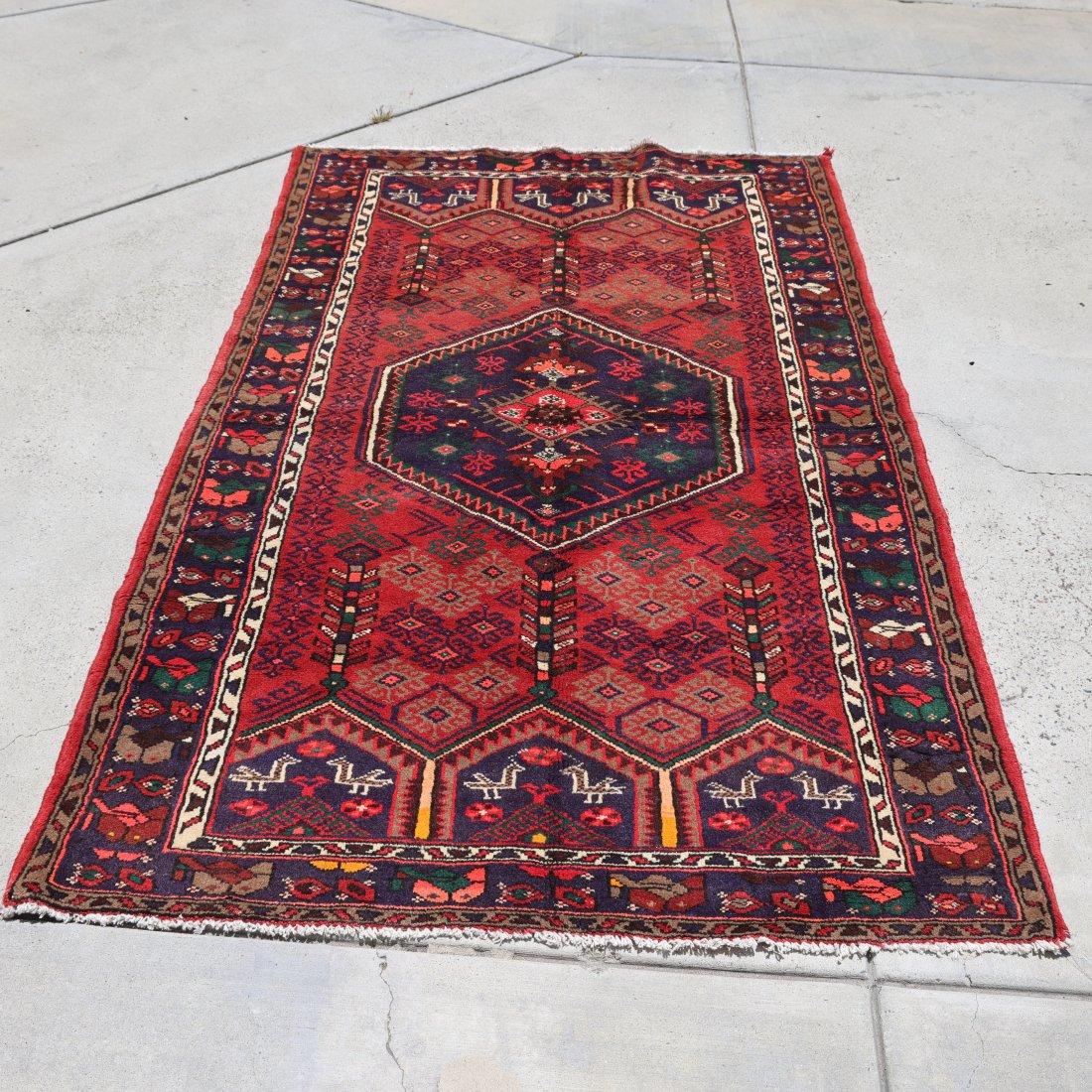 Handmade Antique Persian Rug 4*7 FT: Add a touch of elegance and history to your space with this exquisite antique Persian rug. This beautiful piece features a captivating red field with intricate geometric and floral patterns, showcasin