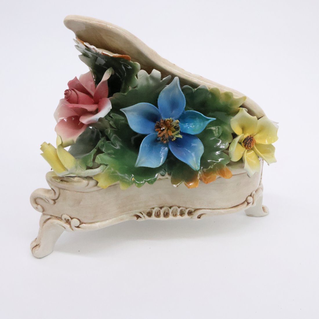 Vintage Capodimonte Floral Porcelain Piano Figurine - Made in Italy: Delight in the timeless beauty of this vintage Capodimonte porcelain piano figurine, expertly crafted in Italy. This charming piece showcases an array of meticulously hand-painted flowers, bursting wi