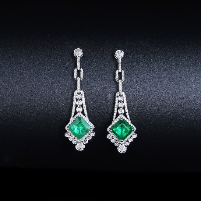 14K White Gold 2.17 CTW Emerald & Diamond Earrings: Ref:1123533 Gold Content:14K White Gold Total Item Weight:3.18grams Ring Size:10.43*35.34mm Main Stone:Emerald Number of stones:1 Shape:Emerald Carat Total Wt:1.61ct Color:Green Cut Grade:G Ad