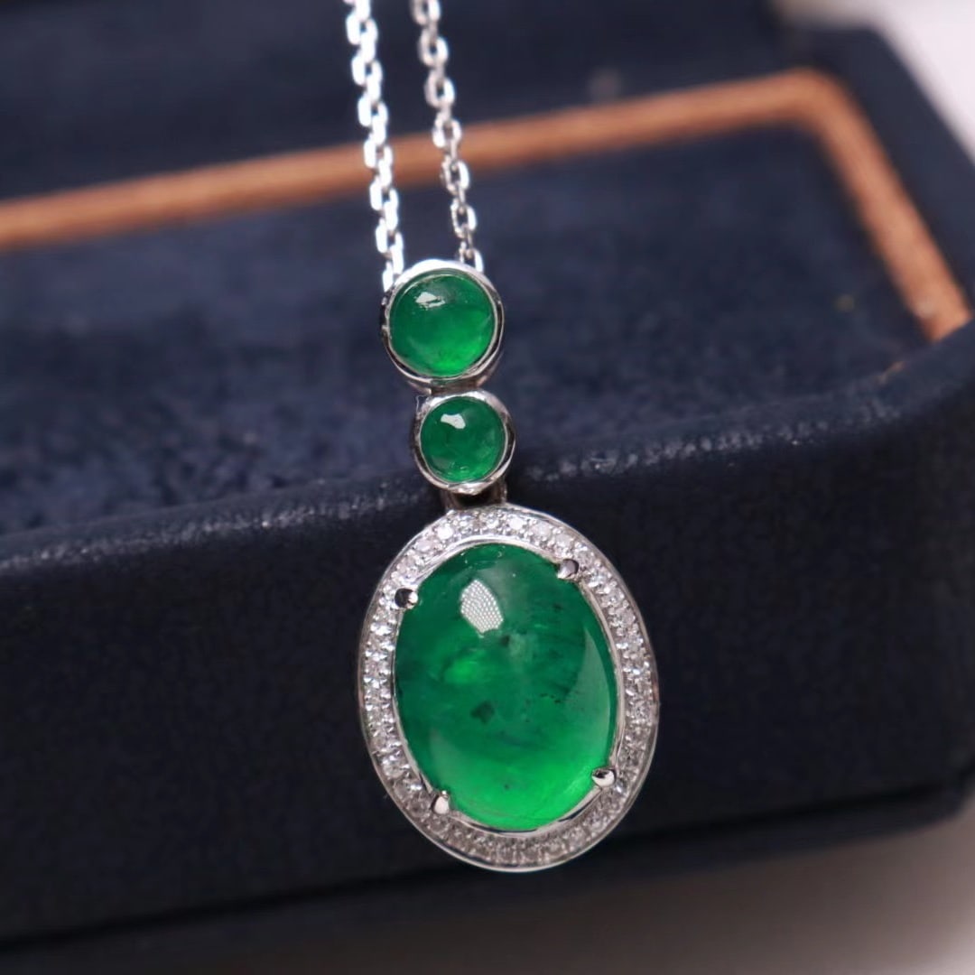 14K WHITE GOLD 3.752 CTW VIVID GREEN NATURAL EMERALD & NATURAL EMERALD & DIAMOND PENDANT: Ref:230712389 Gold Content:14K White Gold Main Gemstone:Natural Emerald Number of stones:1 Shape:Oval Carat Weight:3.60ct Color:Vivid Green Cut Grade:G Adjacent Gemstone 2 : Natural Emerald Number