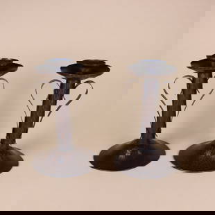 Benedict Studios Arts & Crafts Candlesticks: Pair, Benedict Studios hammered copper candlesticks each with cylindrical bodies and two riveted handles creating a heart. Each signed with impressed anvil shop mark. 7.5" x 3.75". This lot ships