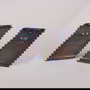 Roycroft Hammered Copper Bookends: Roycroft hammered copper bookends with repousse trefoil, or trillium flower design. Each marked with large early impressed orb and cross. East Aurora, NY. Circa 1920. 6" x 4". This lot ships from