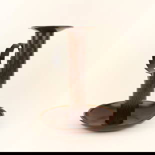 Gustav Stickley Copper Chamberstick, Model 74: Gustav Stickley hammered copper chamberstick, model 74, with original candle bobeche. Marked under base with impressed "Als Ik Kan" joiner's compass. Eastwood, NY. Circa 1910. 9" x 7". This lot