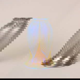 Stueben Pulled Feather Art Glass Shade: Steuben Glass Works, gold Aurene iridescent pulled feather art glass shade. Marked with silver fleur de lis stamp inside fitter opening. 5.75" x 4". Fitter size 2 1/4". Circa 1910. This lot ships