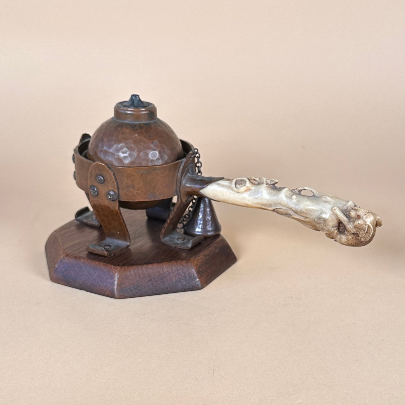 Joseph Heinrichs Cigar Lighter: Joseph Heinrichs gimbal cigar lighter, New York circa 1904. A large Arts & Crafts hammered copper lighter, mounted on an original wood base, silver rivets throughout. Handle made of antler bone, carve