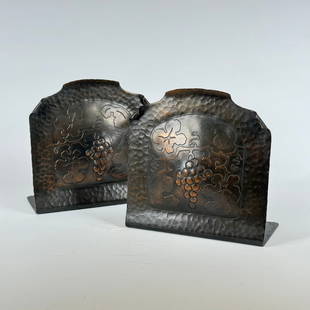 Early Craftsman Studios Grapevine Bookends: Craftsman Studios, pair of hammered copper bookends with acid-etched and repousse grapevine motif. Each signed with impressed conjoined “CS” shop mark. Los Angeles, CA. Circa 1920’s.