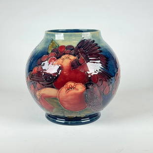 Moorcroft Pottery Pomegranate Vase with Finches: William Moorcroft Pottery, decorated bulbous vase with pomegranates, berries and birds. Marked under base with impressed "Moorecroft Made in England" and arrow, with hand painted cipher. 6.5"h x 7"d.