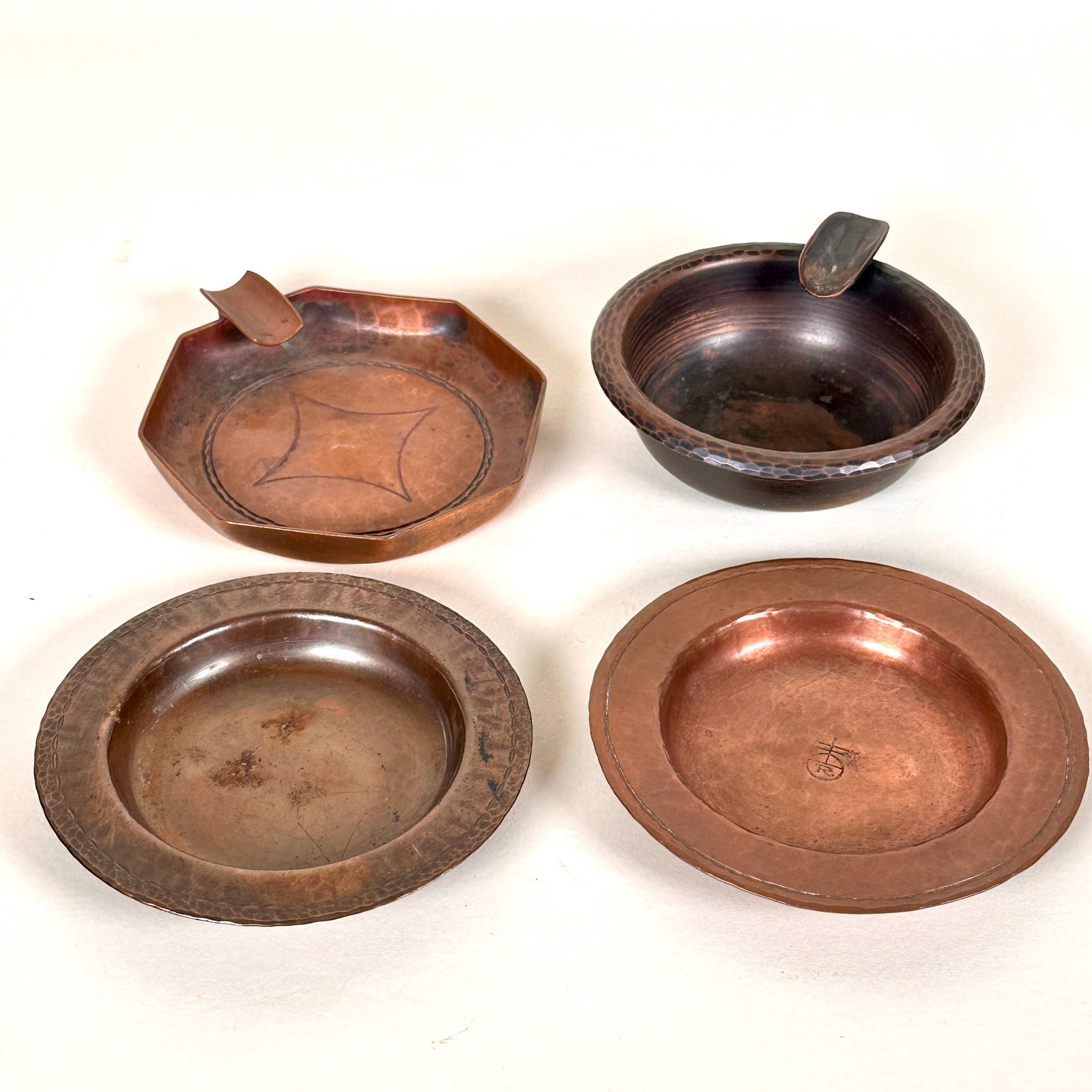 Roycroft Copper Ashtrays (Four): Roycroft copper, set of four ashtrays. Signed. Each measure about 4.25" wide. This lot ships from our California location.