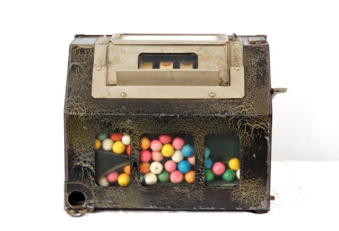 The Lark Coin-operated gum vending machine: Coin-operated gum vending machine with three reels. Shows original award card and reel strips. Circa 1928. One key is provided. Unusual craclature paint
