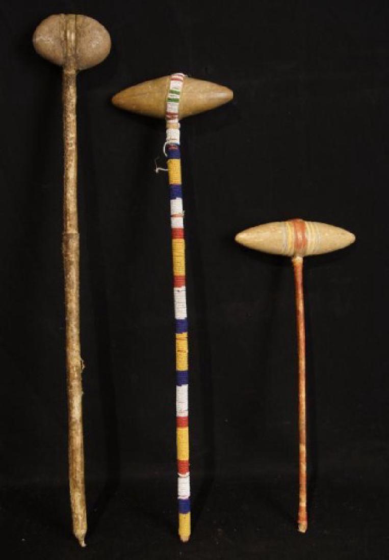 3 Plains Indian skull crackers: The first one measures 27.5" it is stone and rawhide, the stone measures 4" across. The second one measures 24.5" it is beaded and stone carved, the stone head is 7" across. The third one measures 17"