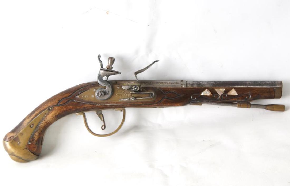 An antique Dutch Flintlock pistol: Carved wood stock with steel & brass furniture, 9.5" approx .45 cal (12cm) barrel and brass side lock both marked L.A.G. AMSTERDAM 1735 . Abalone triangular inlays, looks as though the barrel has been