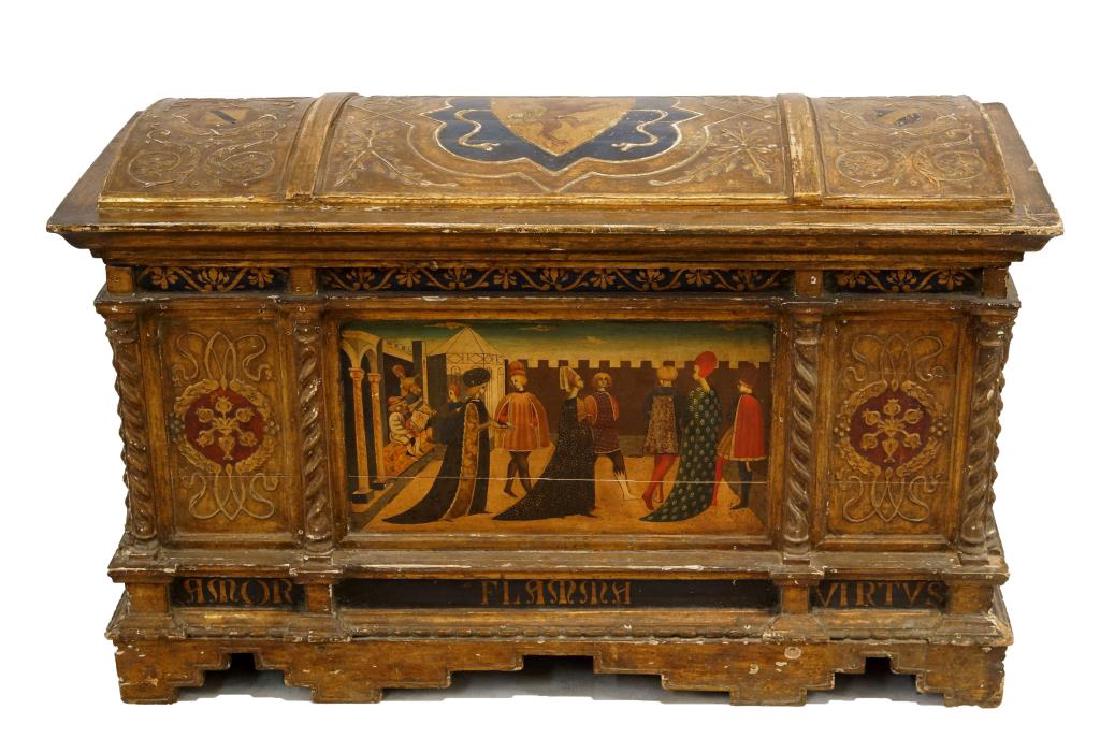 An Antique Gilt painted Italian cassone: hand painted Renaissance court scene front, and large shield with lion top center, each cell has wreaths and vinescrolls in relief, four twisting columns frame the front panels and the words AMOR FLAM