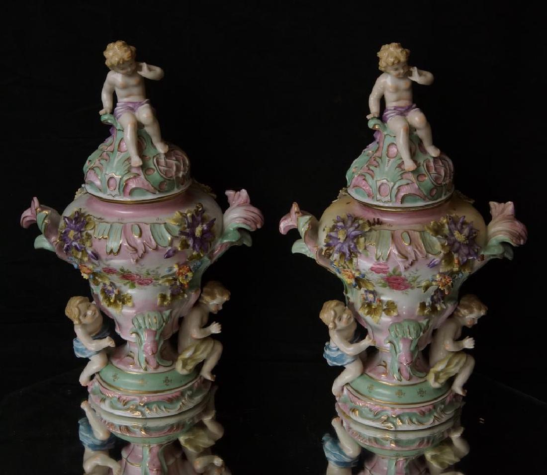 Pair German porcelain "Puti" amphora vases: 12.24" tall w lid Crossed sword mark bottom - Possibly Meissen