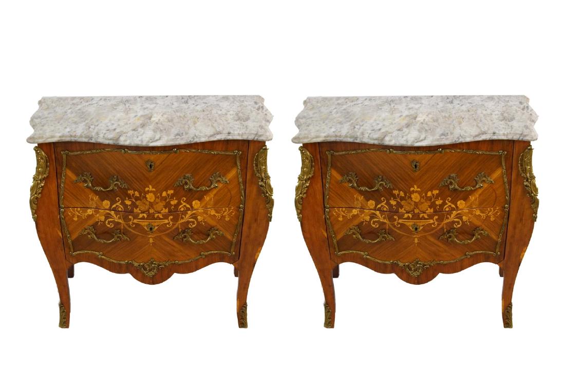 French Louis XV Style marble top Bombay commodes: black and white marble tops, bronze ormolu with oyster motif and wreathes, and a single urn and floral motif split between the two front drawers with two side vignettes of trumpeting flowers each meas