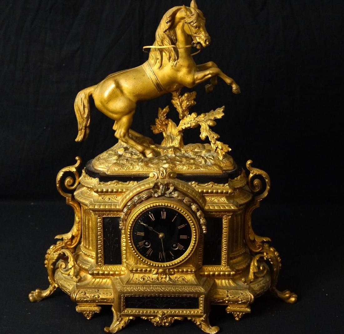French Bronze clock with cast horse atop: works read 'Etablishement H. Mdle 97 Paris' Black face, claw feet, Louix XVI style ribbons and flower wreath over the face, black incised panels- back missing measures 18" H x 17" w x 7" d
