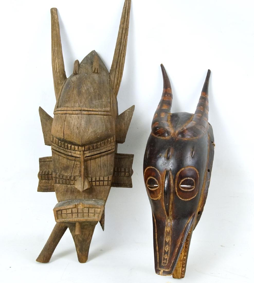 Ivory Coast Guro Zamble & Senufo Ceremonial Masks: a 16.5" Ivory Coast polychrome painted Guro 'Zamble' mask (half human , half animal) half human face, with slit eyes framed by a circle, and a small, curved nose without nasal wings, below the nose th