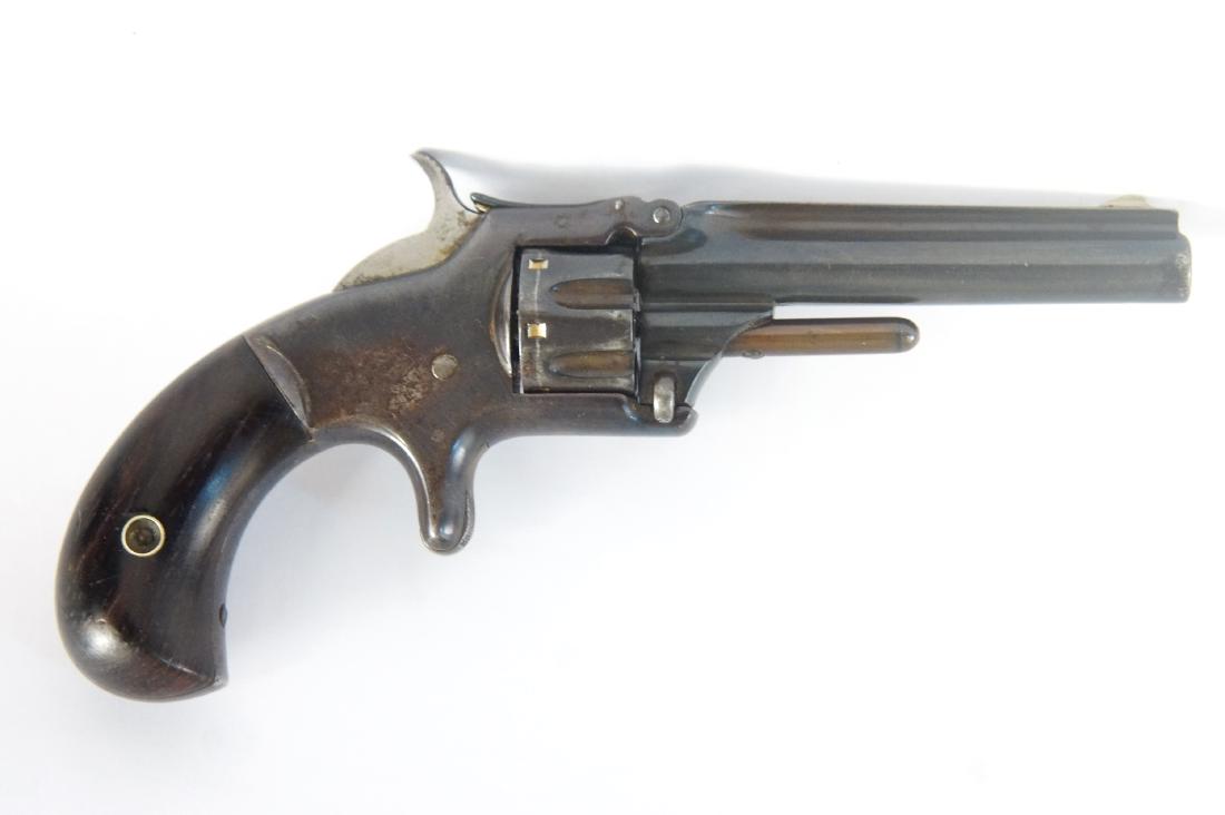 Antique Smith & Wesson Mod. 1 3rd Issue Revolver: Serial # 126298 over 90% original blue, spur trigger, top break 22 short 3.25" round blued barrel with bass blade sight, wood grips, a true piece of history approx 1879. fluted cylinder, a round barre