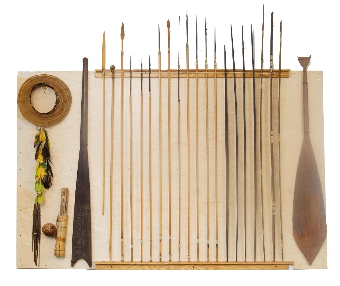 Amazon Bow & Arrows display: mounted collection of 2 paddles, 7 bows, 12 spears, hat w feathers and poison dart holders Provenance: Acquired 1940-1950 by Mr. Norton while working as an engineer in the Amazon