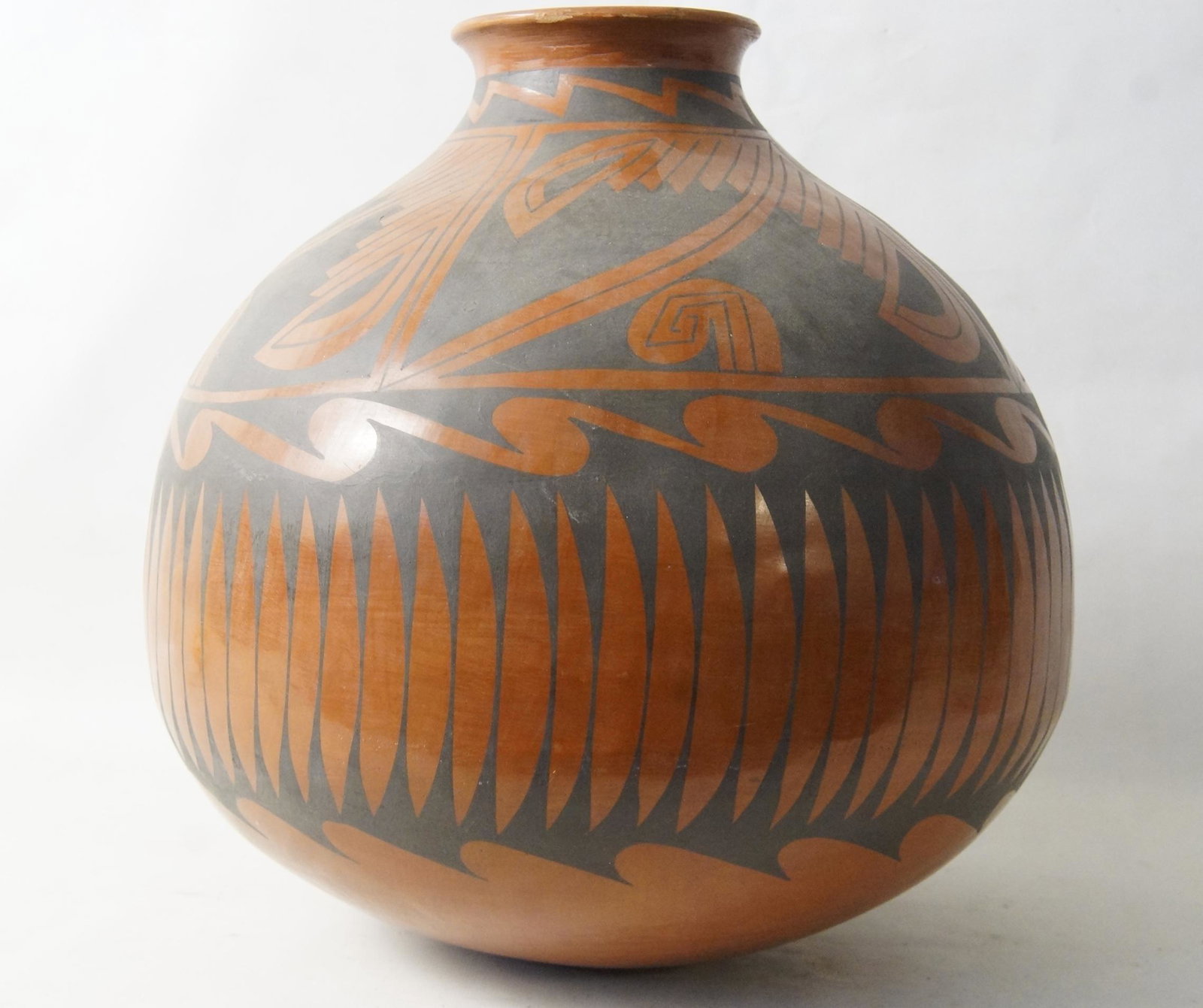 Mata Ortiz potter Gloria Hernandez Casa Grande jar: signed bottom Gloria Hdez (Gloria Hernandez) of Mata Ortiz, Mexico. A red earthenware jar with polychrome red and black slip with black feather and geometric design, Casa Grande style measuring approx