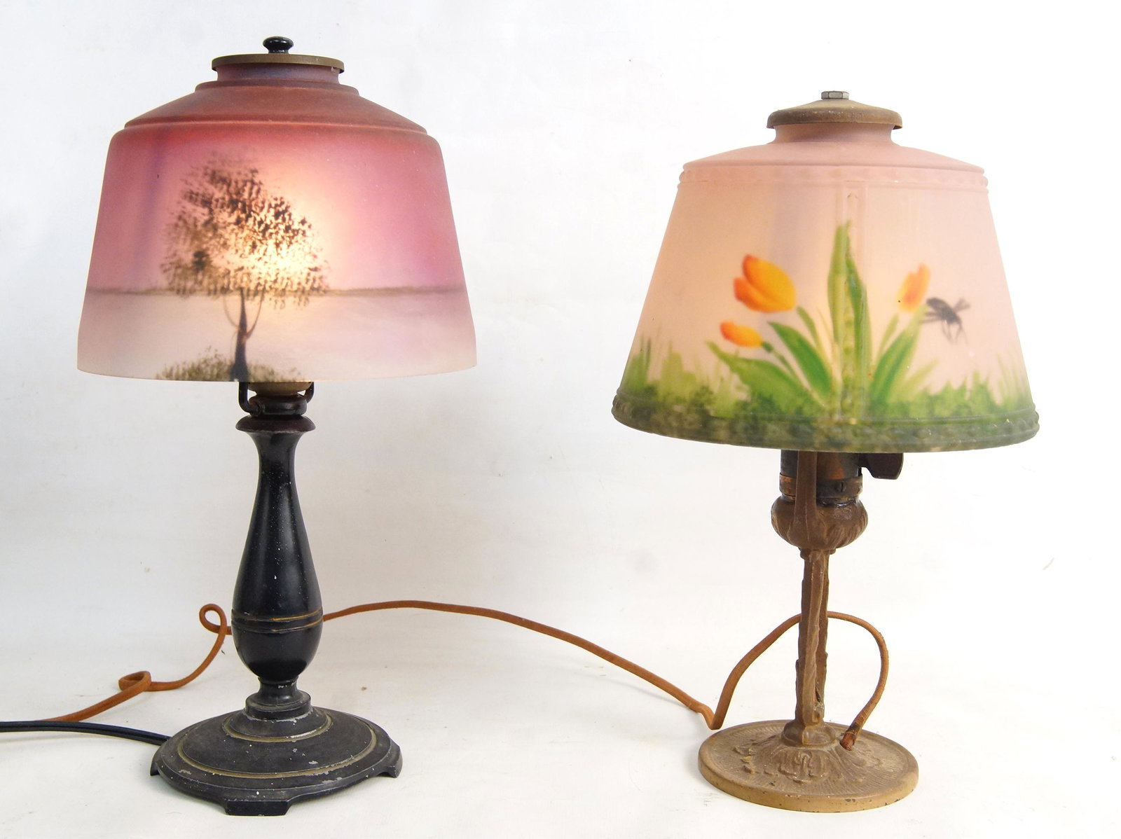 Antique frosted reverse painted Boudoir Lamps - 2: Two reverse painted stained glass shades one with a dual tree image, the other with a dragonfly among the grass and flowers each measure approx 12.5" and 13.5" H x 8" and 7" diameter