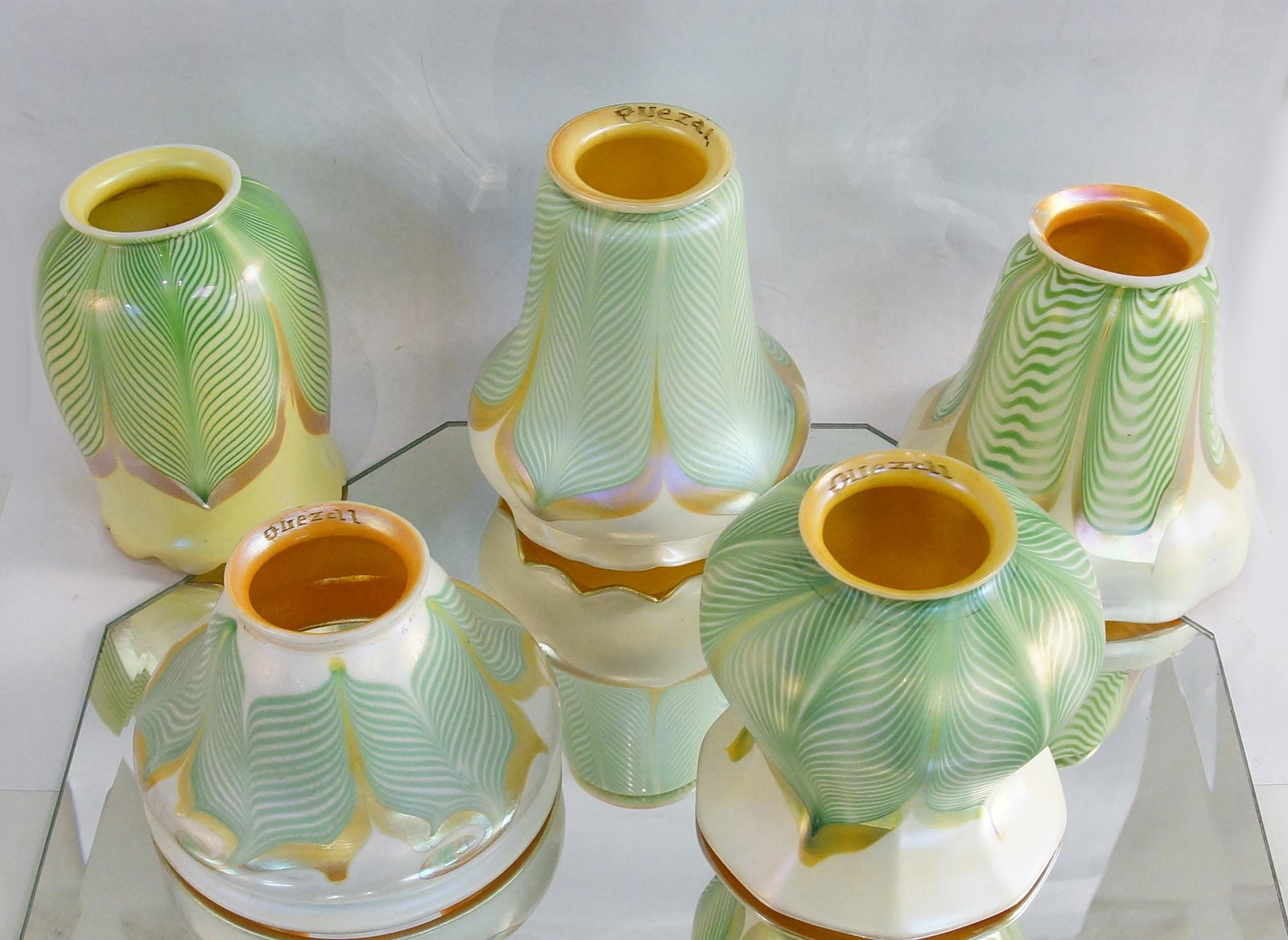 5 Antique Steuben & Quezal pulled feather shades: assortment of Iridized art glass pulled feather Aurene and Quezal glass shades The tallest measuring 5.5" the smallest 3.5" x 5" diameter