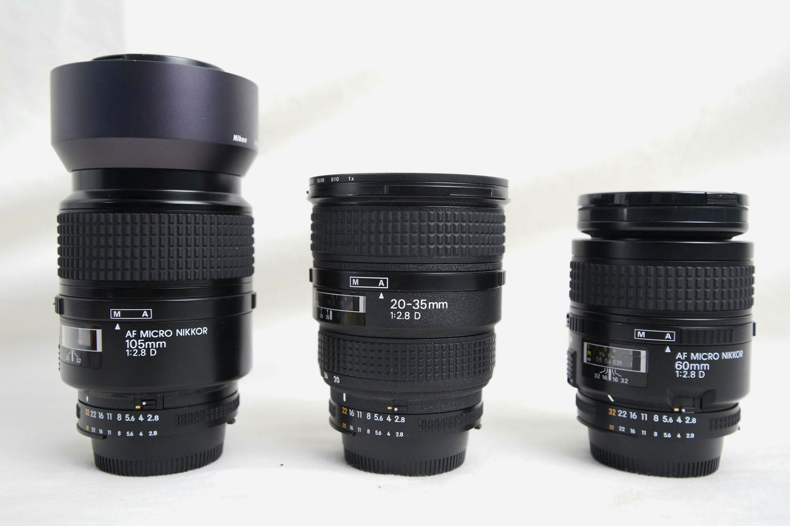 Three Vintage Nikon Lenses: Nikon Micro-NIKKOR 105mm f/2.8, Nikon -NIKKOR 20-35mm f/2.8, Nikon NIKKOR Micro 60mm f/2.8 D