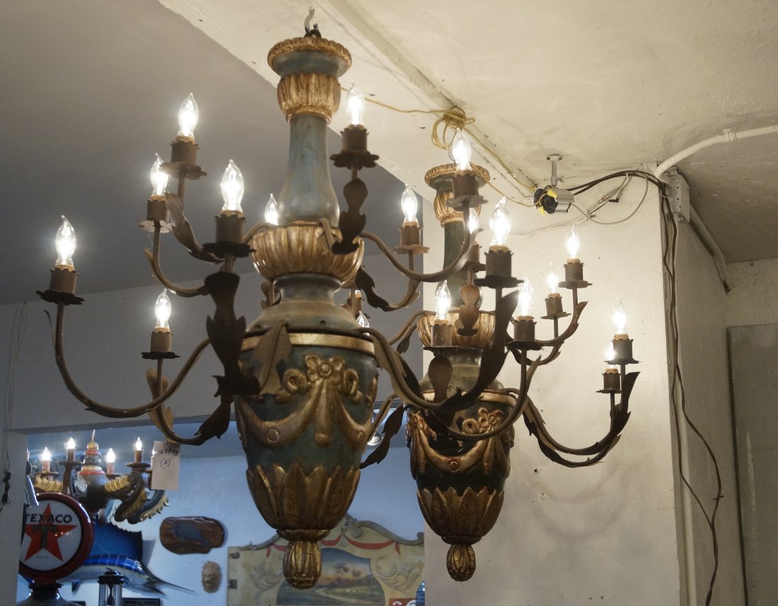 2 Spanish Colonial hanging 12 light chandeliers: Polychrome painted and wood carved central plunging base with green and gold embellishments of ribbon and leaf crowns with wrought iron arms wood - Antique with twelve lights Provenance: Santa Barbara