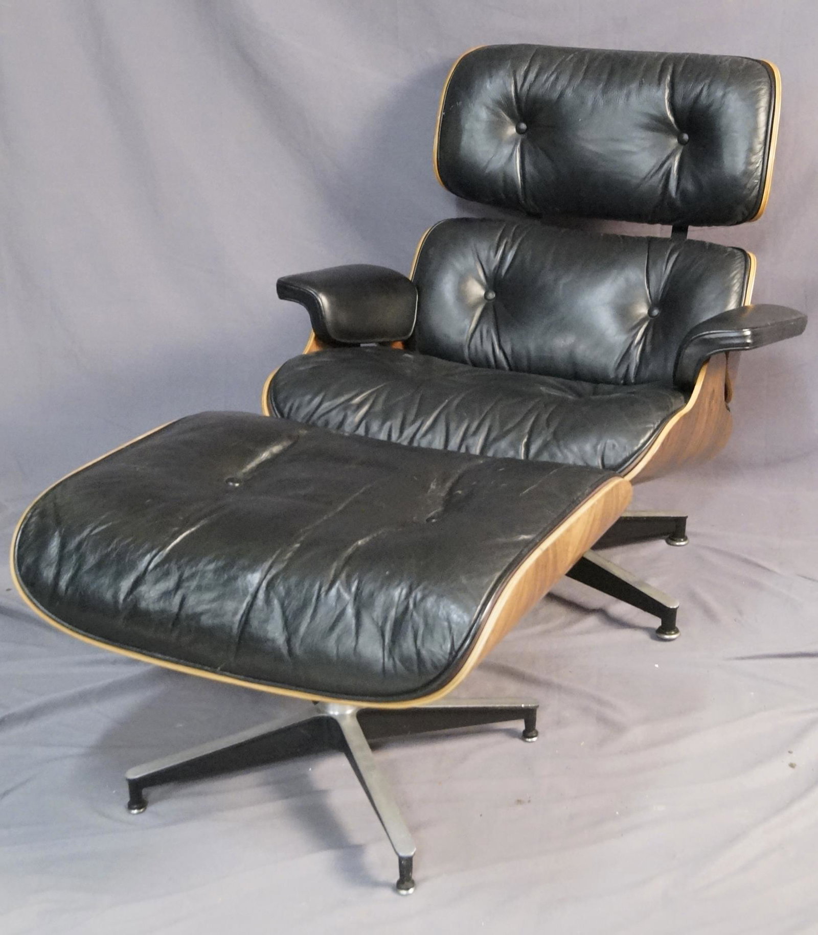 Charles and Ray Eames Lounge Chair and Ottoman: Charles and Ray Eames (1907-1978 &1912-1988)Lounge Chair and Ottoman, model 670 and model 671for Herman Miller, USA - rosewood plywood, leather, enameled aluminum, rubber. Manufacturer's paper labels 