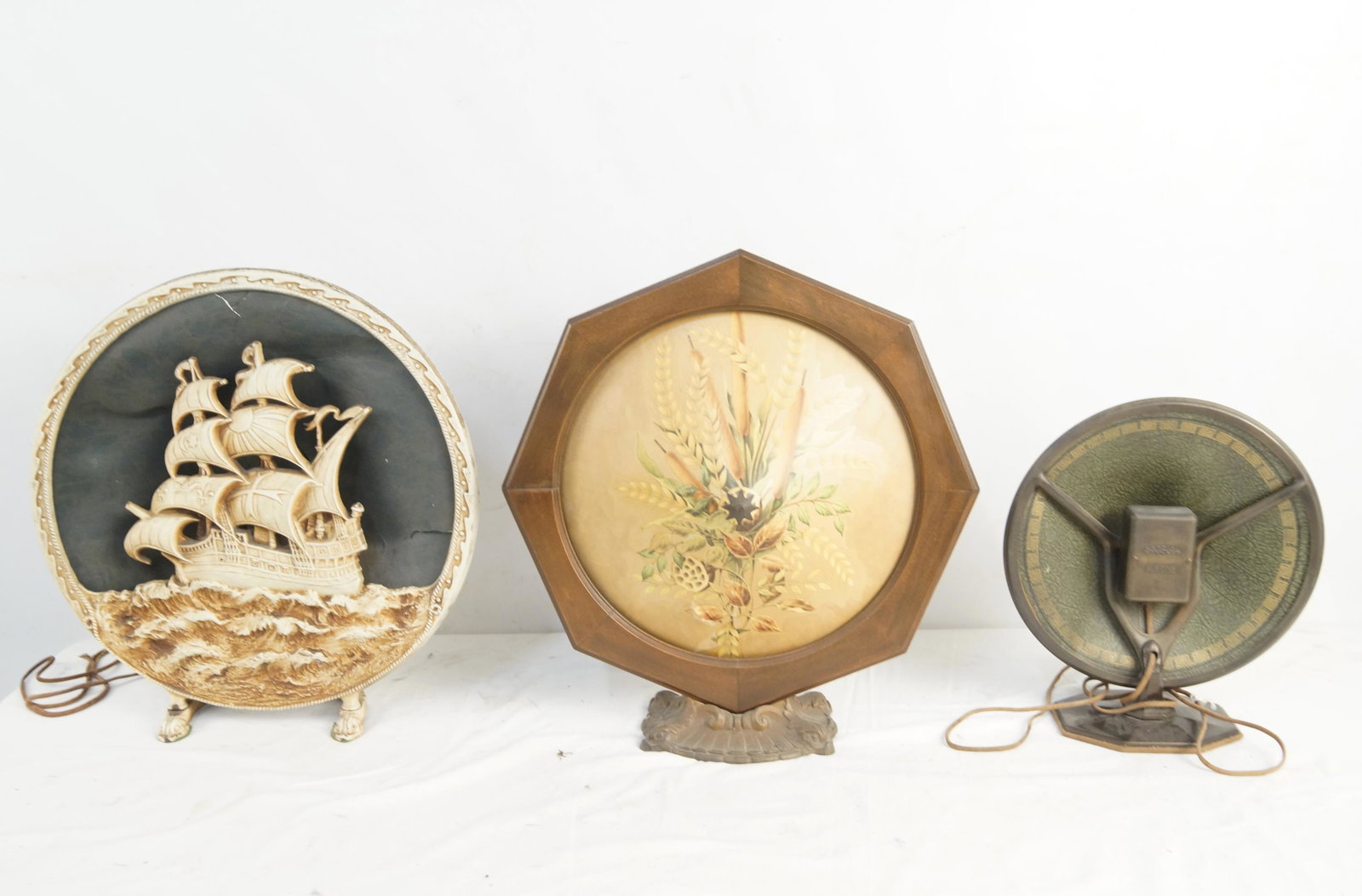 Three Antique 1920's Radio Speakers: a small Crosley musicone 11" Speaker, a Tower Adventurer 18" cast iron speaker with a sail ship, and a very nice Art Nouveau 19" wood and paper cone speaker with a bouquet pictured front.