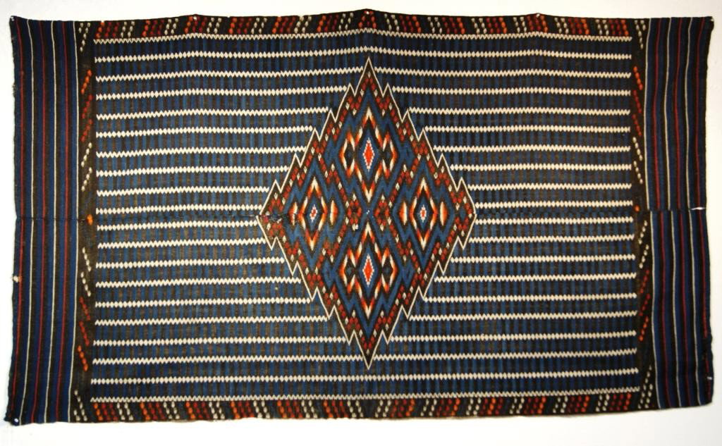 Antique Mexican Saltillo circa 1910: measures 25" x 78". Red, White, Blue and Black stripes inhabit the piece, centered an Orange, Red, White , and blue zip zag diamond holds four diamonds sections also filled with diamonds. Outstanding 