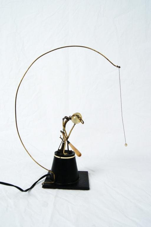 Gordon Brandt Kinetic Sculpture - man hits ball: signed on base. Sculpture uses an ac plug (switched), stick man slowly coils back, and it quickly released, striking the hanging ball, which spins over the top.