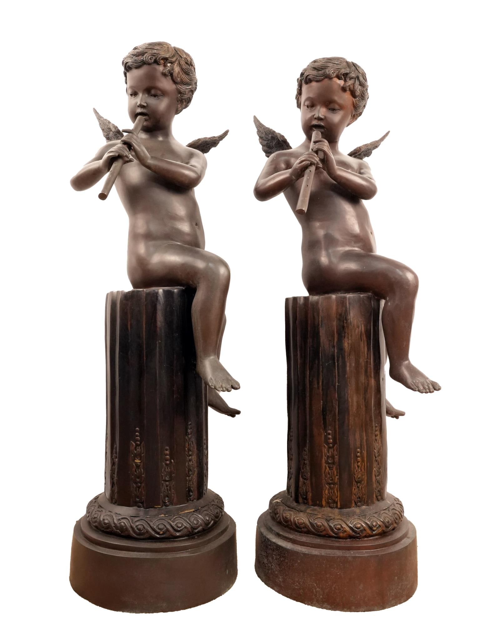 After Joseph D' Aste Bronze Pair of Winged Cherubs: After JOSEPH Dâ€™ASTE playing flutes - app 42" tall x 19" w x 18" winged cupids seated on bronze pedestals