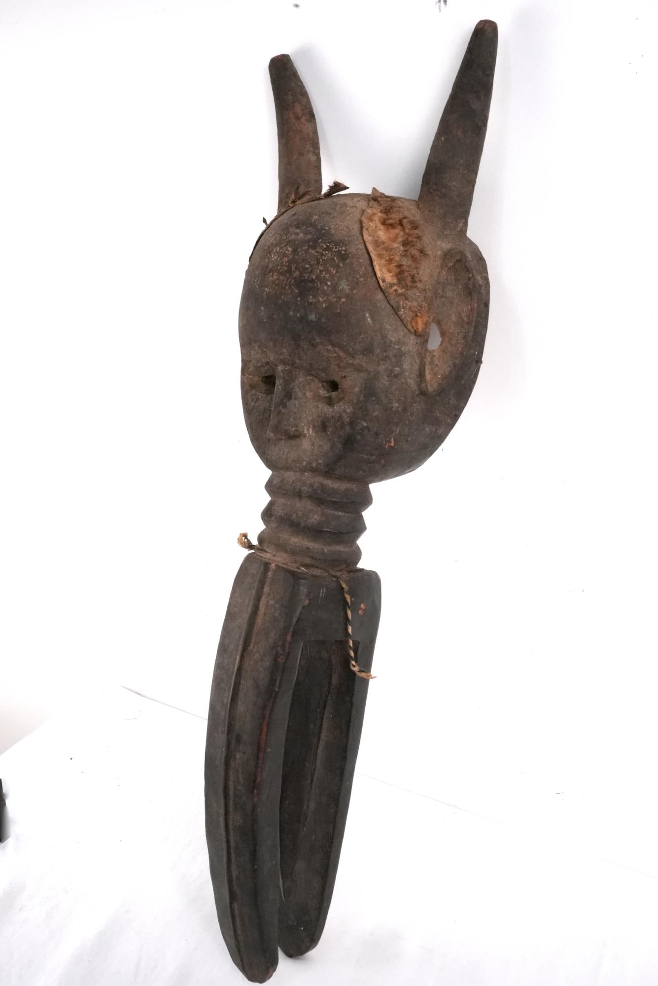 Antique KÃ²mÃ² Helmet Mask Bamana peoples, Mali: Wood Carved and painted with twine and animal hair, the horned mask descends into a large mouth Measures approx. 35" x 9" x 8" Ref: MET Provenance: Noted Montecito, California African Collection