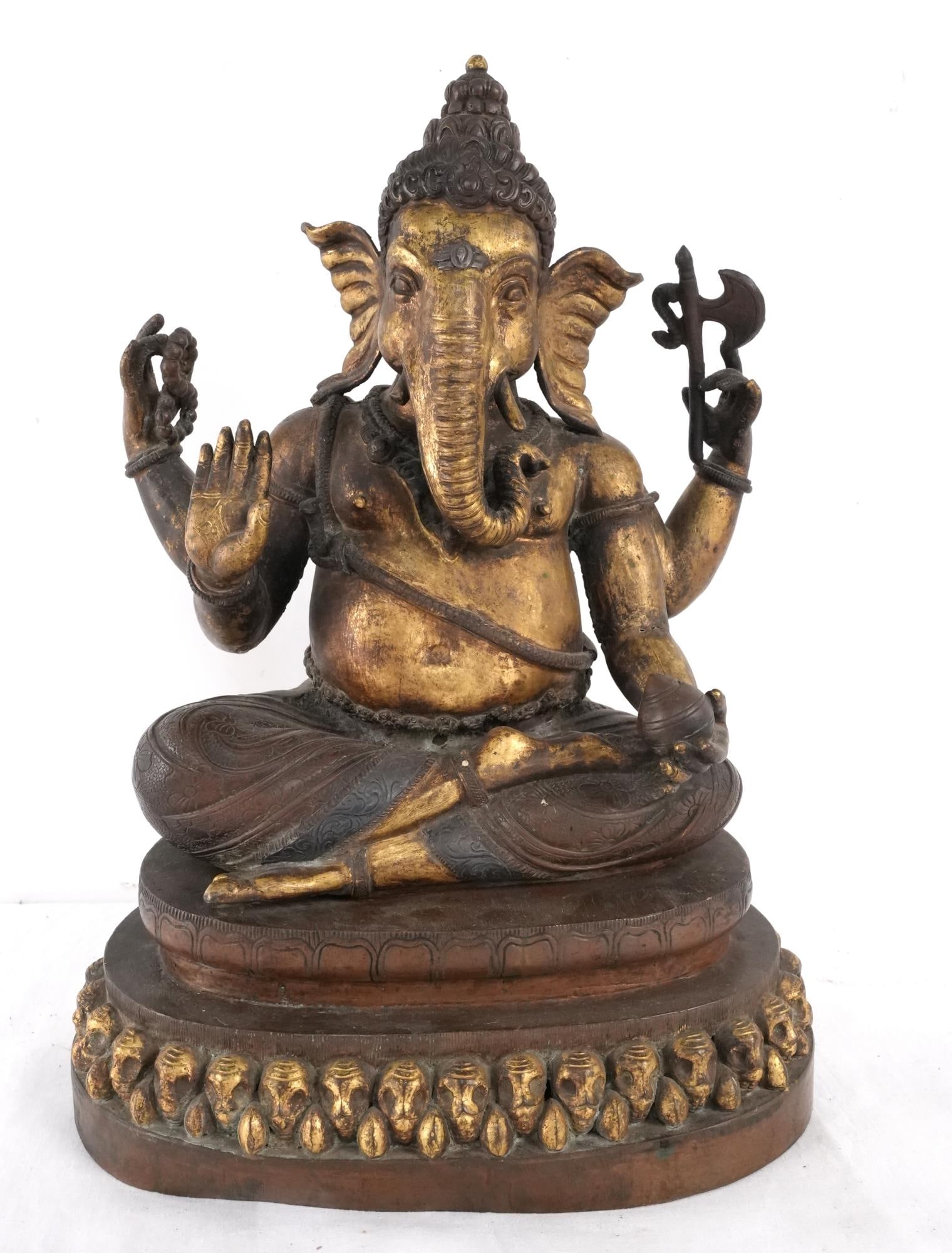 Antique Sino-Tibetan Bronze four-arm Ganesh: Finely cast floral design in pant, excellent detail Shows authentic age, seated upon a base with repeating heads, sand cast with gold overlay throughout measures approx. 17" x 11" x 6" Provenance: Mon