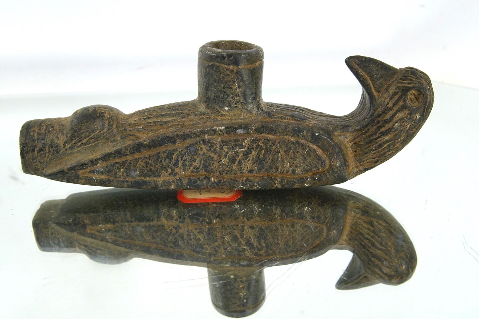 North American stone carved Great pipe Raven: pre historic Raven Effigy steatite carved pipe. Eyes have beveled holes for a gem or shell eye Shows age and wear marked. - Metcalf Co. Ky measures 6.5" x 2.25" x 1 1/8" - Provenance: TJ Lindgren life